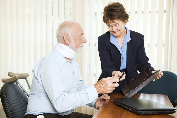 Injured man signing a settlement offer from the attorney.