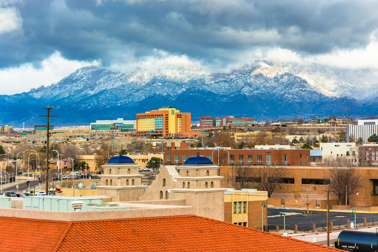 36571774 – view of distant mountains and buildings in albuquerque, new mexico.