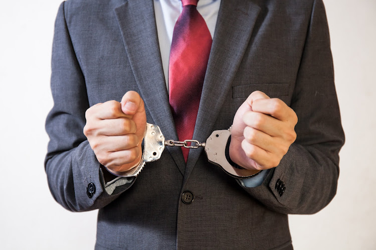 Business man criminal handcuffed