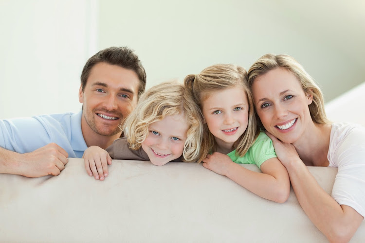 Smiling family together on the couch